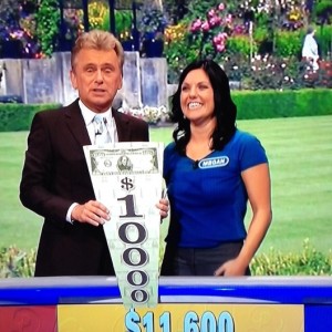 Longtime “Wheel of Fortune” host Pat Sajak shows off Megan Freemole’s $1000 prize. Freemole, a Spanish teacher and track coach, finished in second place during “Wheel’s” teacher week in October.