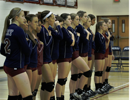 Volleyball girls line up for National Anthem