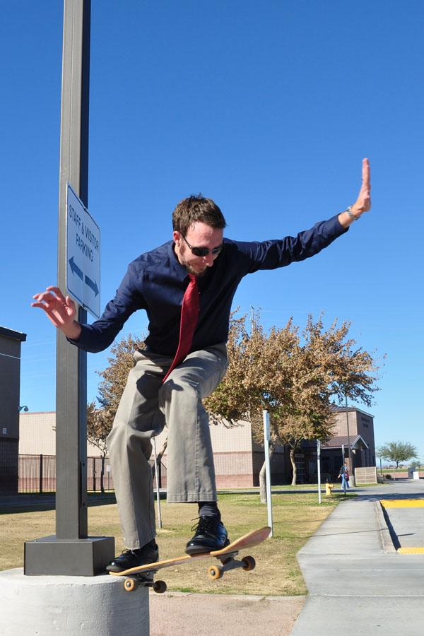 showcasing his skateboarding talent, Myers tries doing a trick off of a nearby lampost.