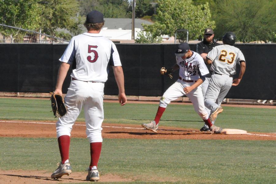 Senior pitcher Kade Bishop (5) looks on as sophomore first baseman Tyler Watson makes a tough play in the field.