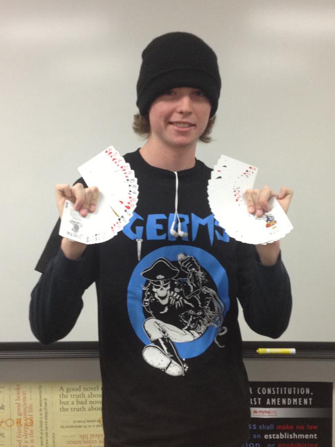 Balentine Poses with his cards after performing magic for students.