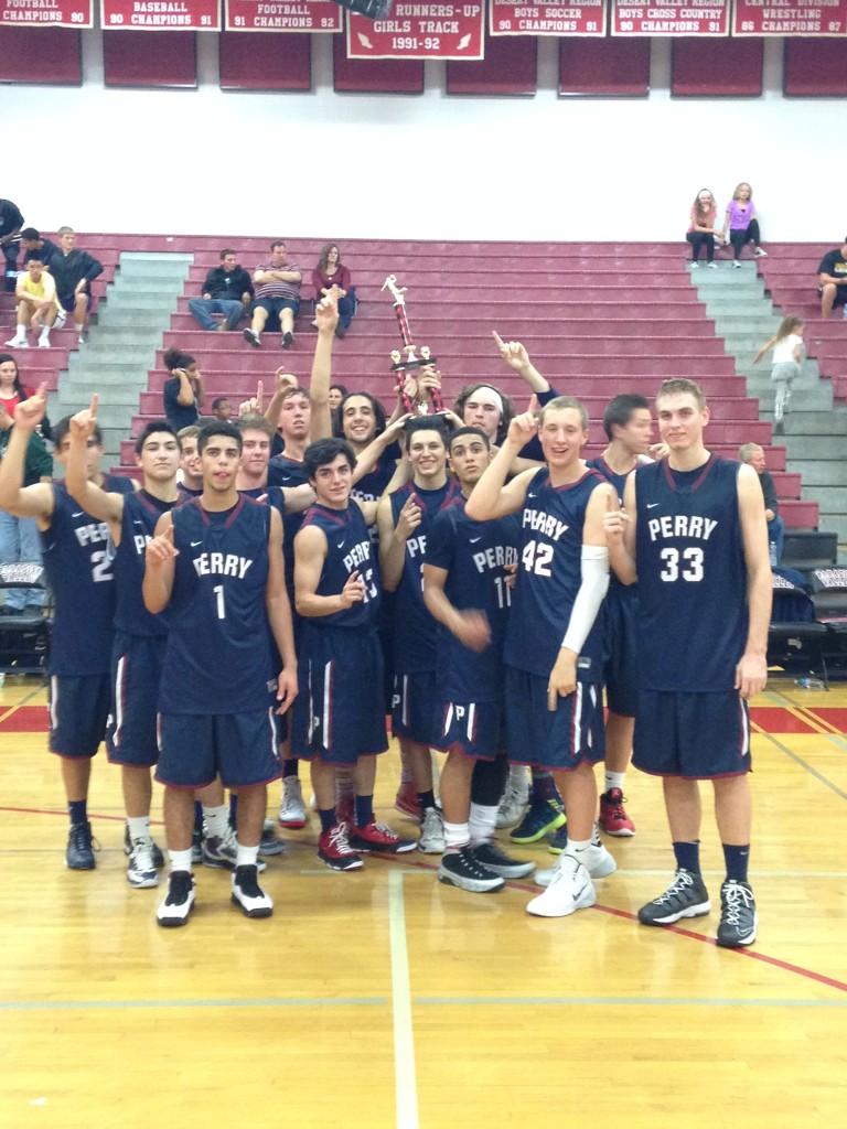 The basketball team poses for a photo after winning the Paradise Valley Invitational on Saturday, Nov. 30.