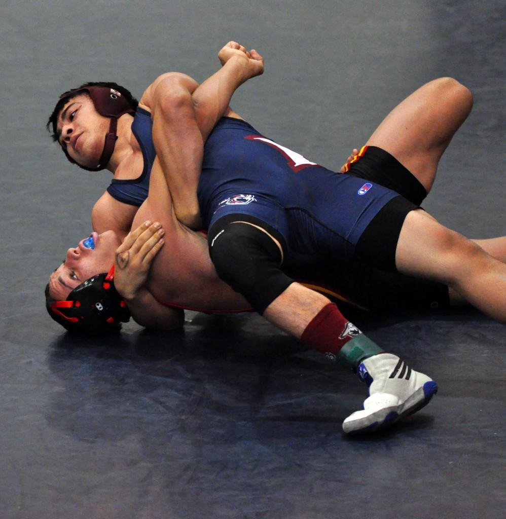 Senior Angel Melendez attempts to pin an opponent.