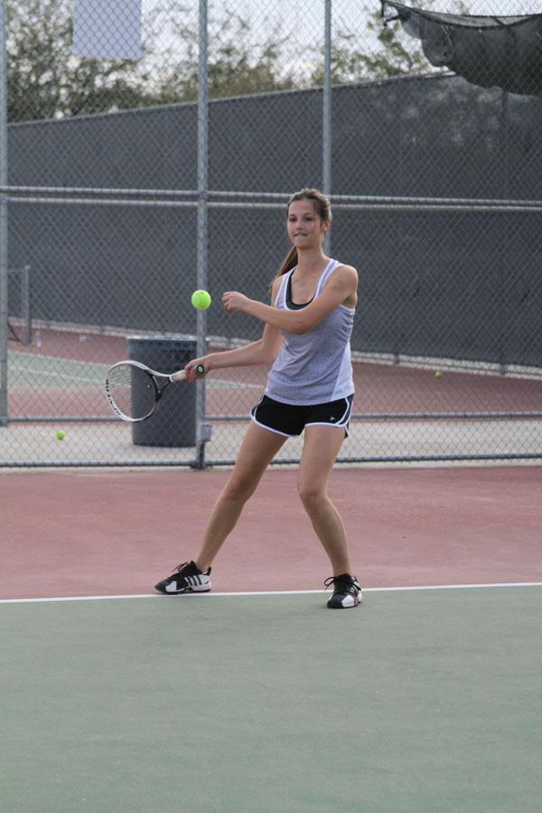 Varsity+tennis+player%2C+Audrey+West+%2810%29+hits+a+forehand+at+tennis+practice+on+the+Feburary+23%2C+2013.+