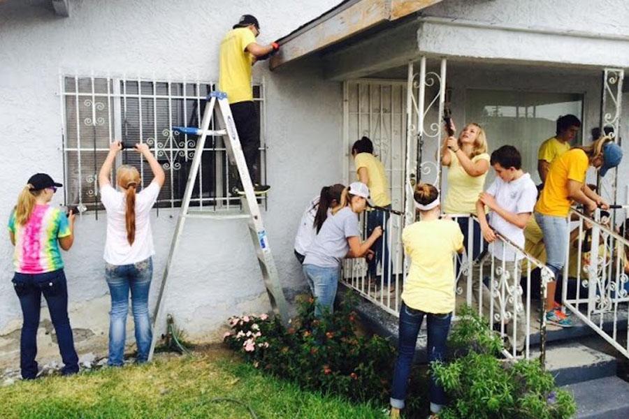 Freshman, Madi Gavin helps with the Grove Bible Church in Compton, Cali. helping to repair and paint a house.