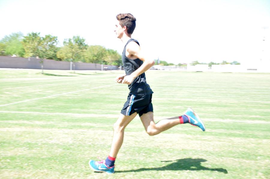 Varsity runner and team captain, Cade Burks, practicing at Perry high school.