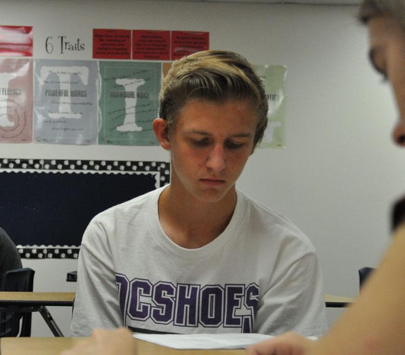 Junior Kyler Gorman analyzes essays in a group format during  Cindy Pino’s AP English class.