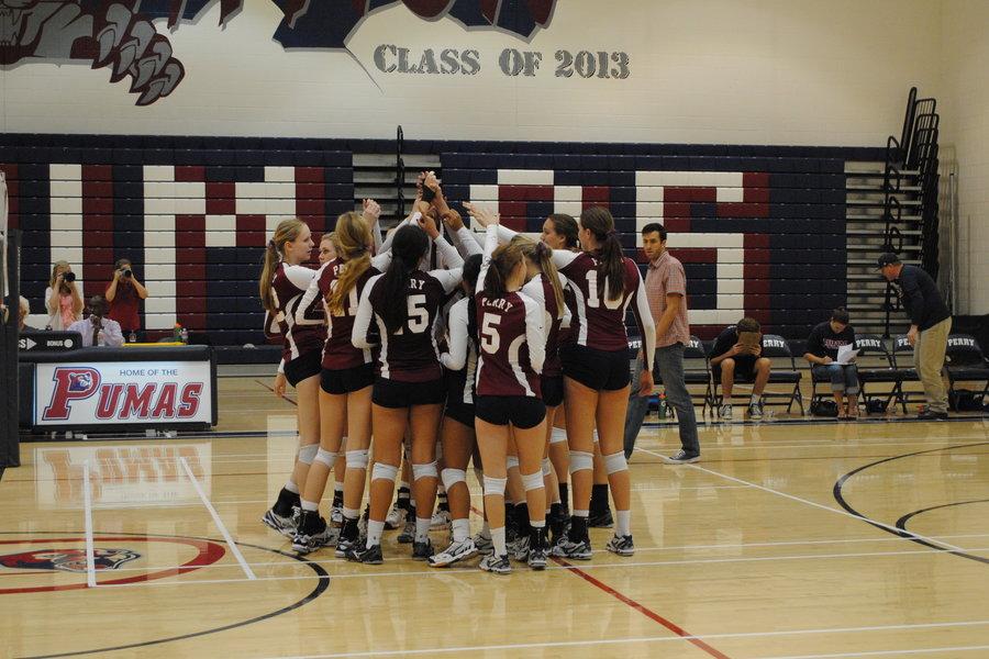 Girls Varsity Volleyball team celebrates their first home win of the season