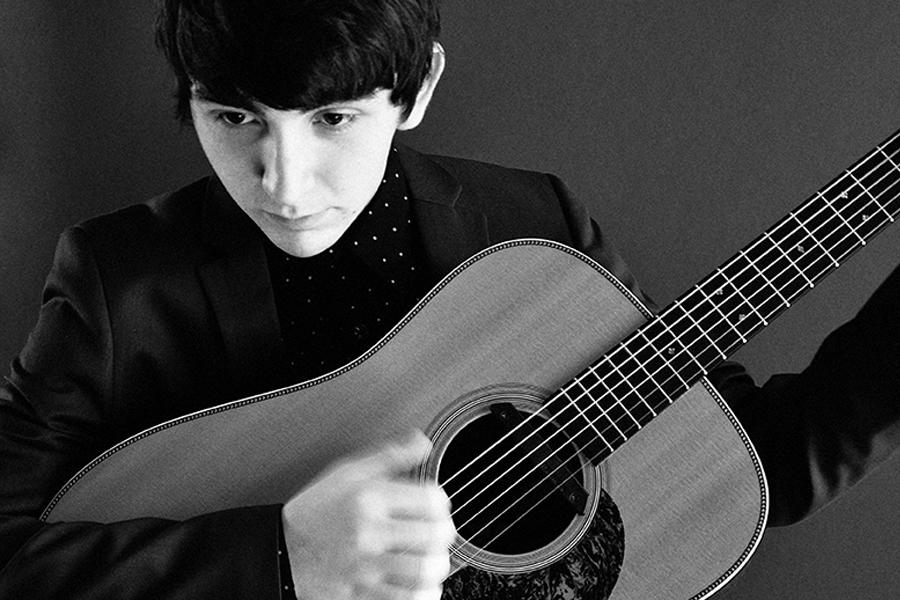 Teen+artist+Dylan+Gardner+strums+his+acoustic+guitar.+Gardners+debut+album+Adventures+In+Real+Time+was+released+in+early+2014.+Photo+used+with+permission+from+gomoxie.org.