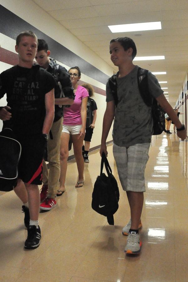 Freshman Marcus Behling (right) walks down the hallway on his way to class. Over the summer, Behling went to the semi-finals in the national spelling bee. 