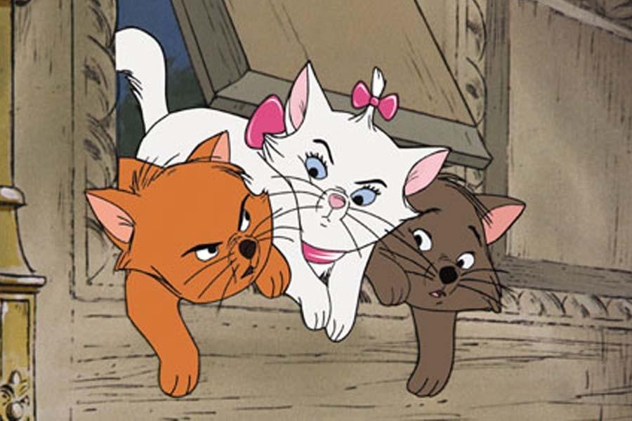 Kittens Toulouse, Marie, and Berlioz shove through the cat door of their expensive mansion home (Disney).