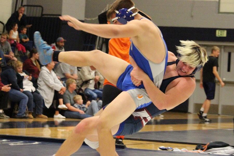 Colton Evertsen takes down opponent during a wrestling meet. 