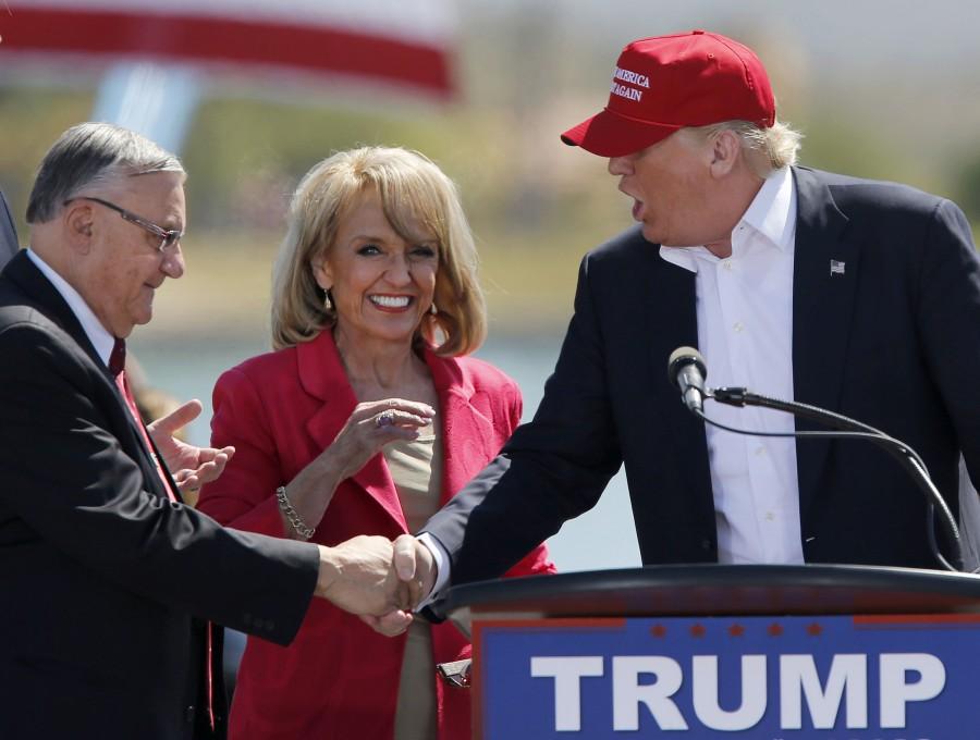 Maricopa County Sheriff Joe Arpaio, left, and former Arizona governor Jan Brewer, center, greet Republican presidential candidate Donald Trump at a rally at Fountain Park in Fountain Hills, Ariz., on Saturday, March 19, 2016. Arizona holds its presidential primary on Tuesday. (Allen J. Schaben/ Los Angeles Times/TNS)