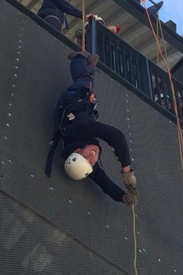 Junior Matthew Jones rappels down a seven story building as part of his training for Fire Science. 