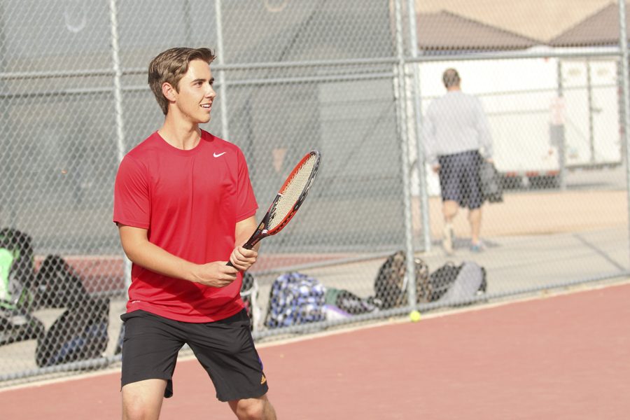Kyle Vance (12) prepares to return a serve on the tennis courts at Perry High School during practice on February 18,2016.  