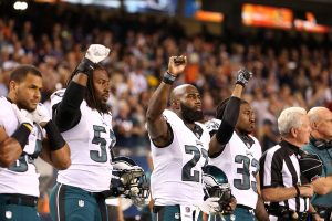 Philadelphia Eagles players Steven Means (51), Malcolm Jenkins (27) and Ron Brooks (33) raise their fists in the air during the national anthem for a game against the Chicago Bears on Monday, Sept. 19, 2016 at Soldier Field in Chicago, Ill. (Chris Sweda/Chicago Tribune/TNS)