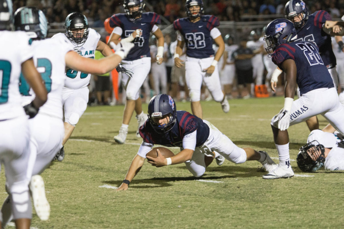 Senior QB, Brock Purdy dodges a tackle from Highland. The Pumas beat the Hawks, 56-6. 
