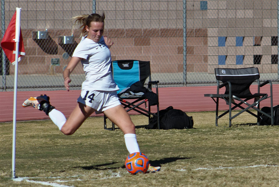 Current senior, Logan VanDine, kicks the ball to her teammates during the playoff game against Chandler on February 4th of last season.