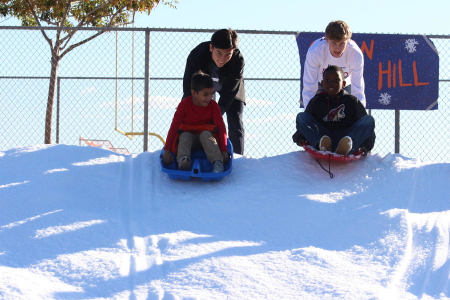Perry seniors Joe Osterkamp and Pearson Wallace enjoy the snow hill with their buddies at Smiles for the Season.