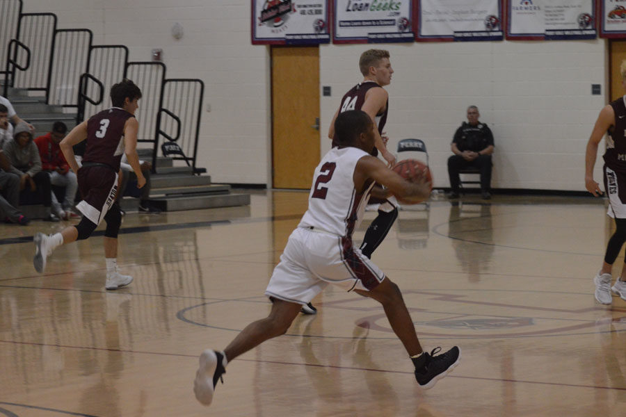 CJ Jamerson runs the court to pass the ball to fellow teammate 