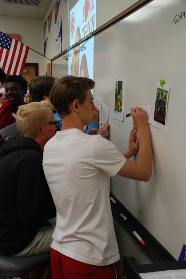 Students work on analyzing fallacies in Nazi propaganda in English Class.