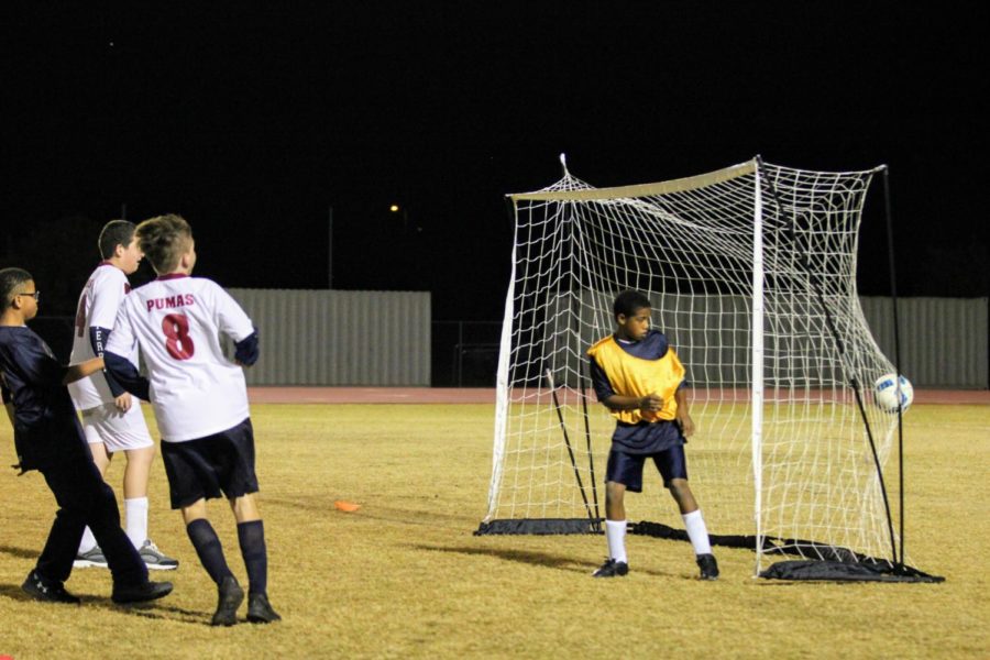 Junior Adam Baumgarth scores a goalin the unified soccer game against Casteel High school on December 5.