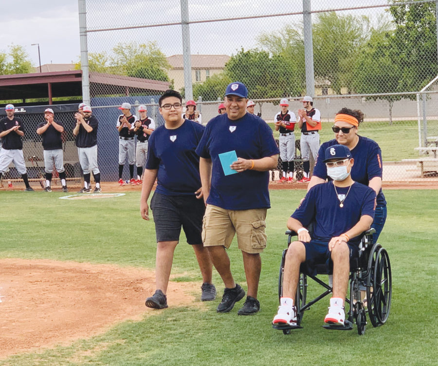 Senior Jacob Medina, in his wheelchair, makes an appearance at baseballs senior night with his family on April 16. Medina, who was diagnosed with Leukemia in March, says he has been amazed with the support he has received from the community.