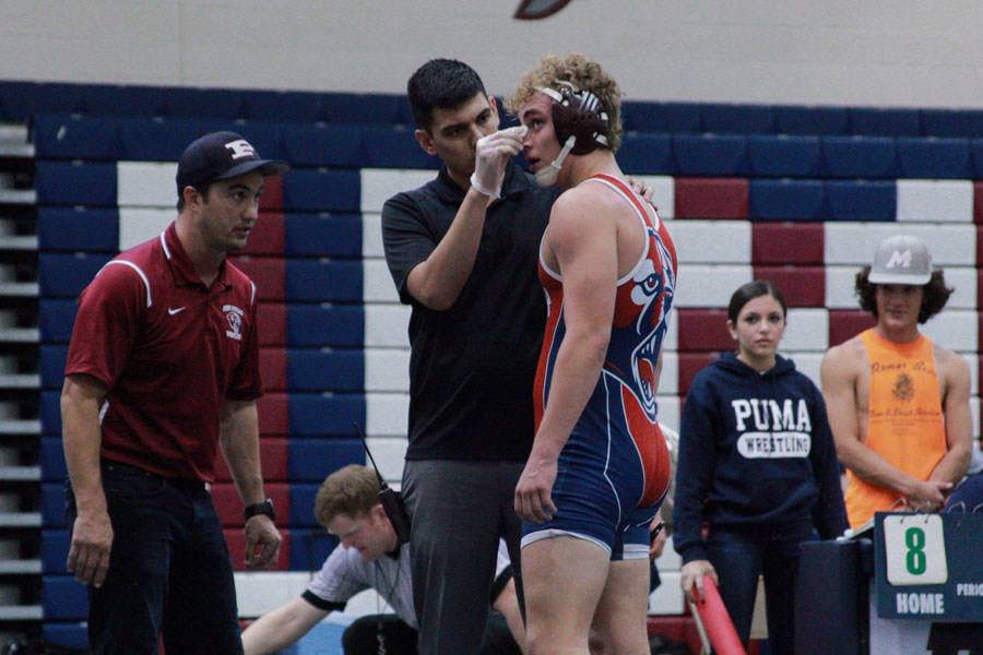 Photo by: Shaynee Young 
Coach Alex Pavlenko speaking to Cooper Call, a Senior, during blood-time