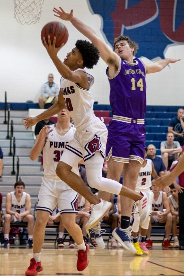 Junior Christian Tuckers goes up for a layup against Queen Creek.