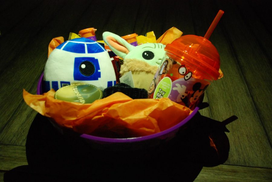 A fully assembled Halloween boo basket. Full of cookies, a Halloween themed cup, and other treats.