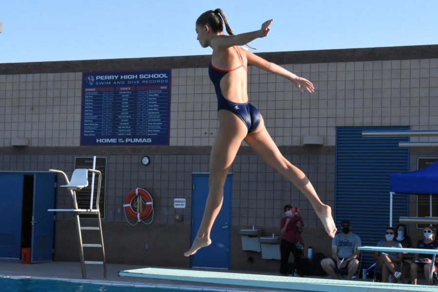 Kenzie Wagner jumps on the diving board  to start off her dive