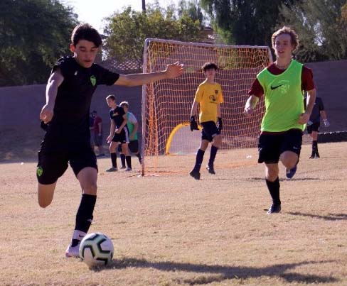 Senior Cole Graham (right) and teammate work on their game play in practice. Soccer has been back up and running since Dec. 7 and has been working hard ever since.