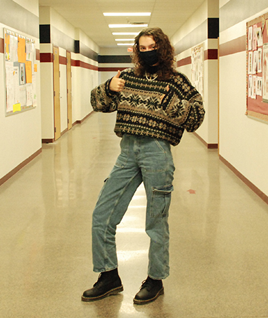 Senior, Natalya Delsante often uses Harry Styles as inspiration for her everyday outfits which she wears around campus. Here, she is wearing a fun patterned sweater, high-waisted pants, and a signature Harry Styles pearl necklace.