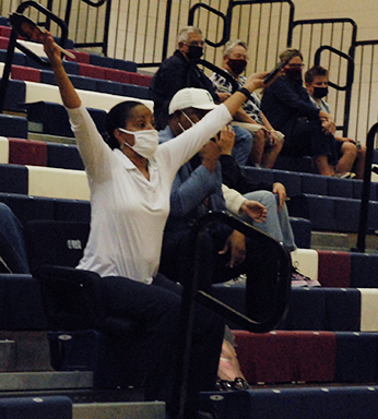 Supportive parent, Rachell Tucker, cheers on the boys varsity basketball at home against Red Mountain. 