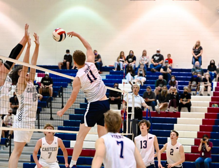 Number 11, senior Camden Neimann, nails a shot over the net while Casteel tries desperately to defend. Neimann is the current team captain for the varsity team.