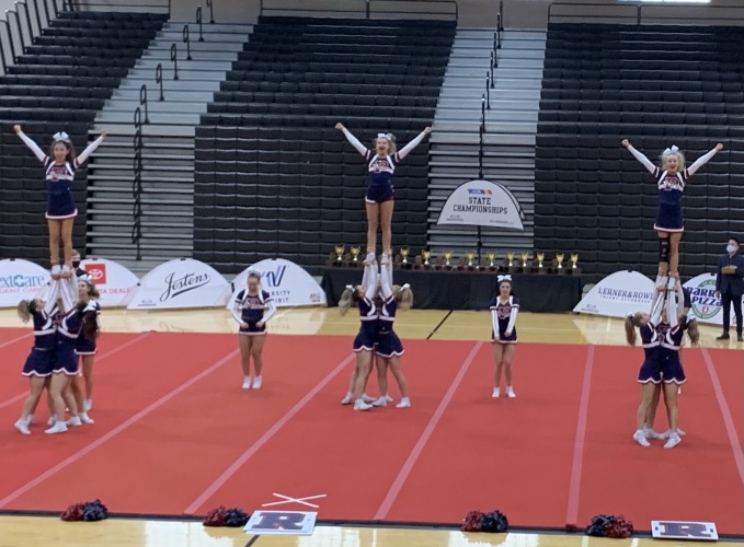 Varsity show cheer takes the mat at state in March. Both pom and cheer will compete at nationals in Florida April 21-25