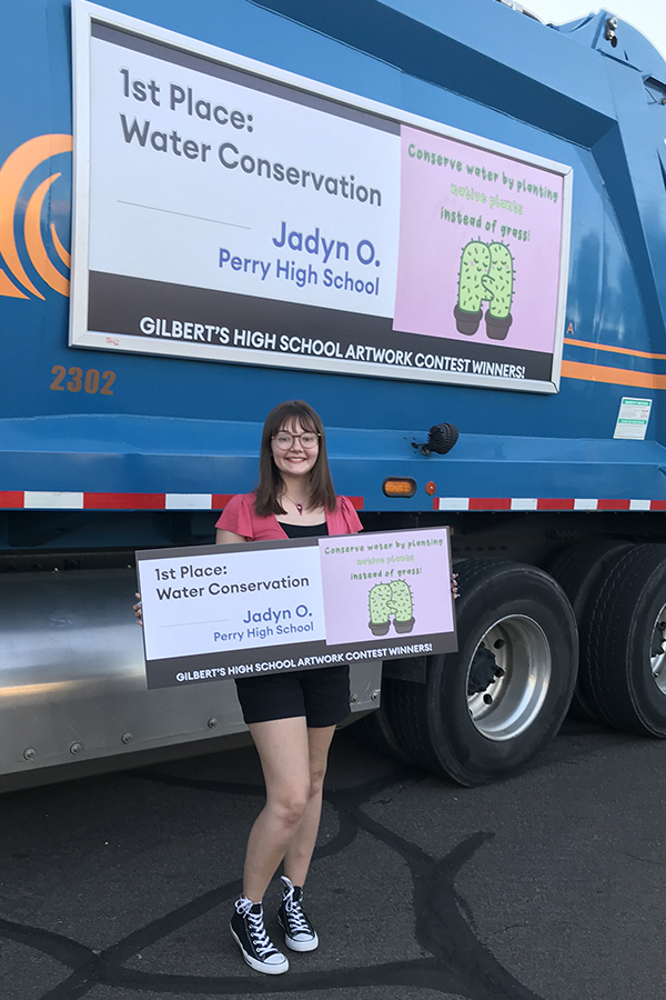 Senior Jayden Ocken standing next to the trash truck that will display her design. Ocken won the City of Gilbert sustainability with her graphic and design of cacti. 