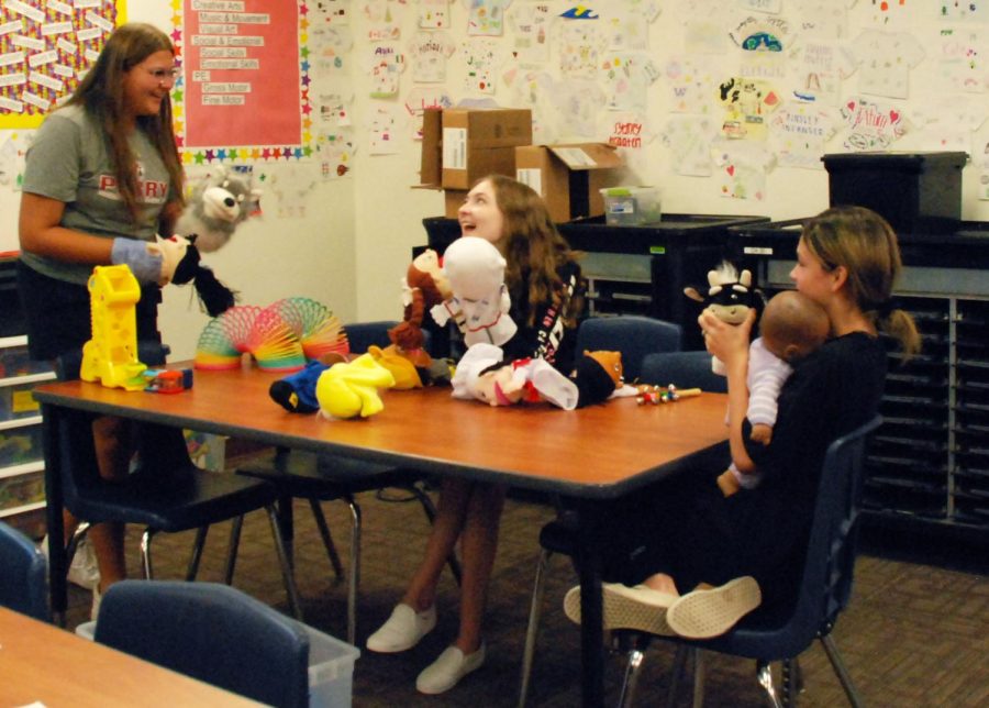 Juniors Lili Stutz, Savannah Nelson, and Shaye Vannorman (left to right) play with toys in Childhood Education. Students completed “play labs,” in which they evaluated the developmental domains and advantages to the toys. 