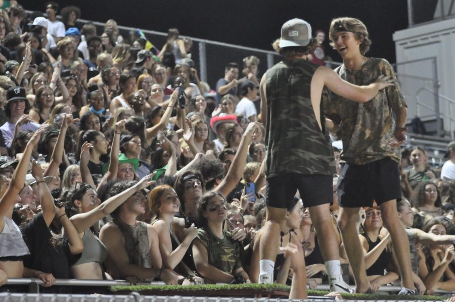 Seniors Cort Cooley and Preston Felker dance on top of the push-up board during a football game. The home game against Basha was camouflage themed. 