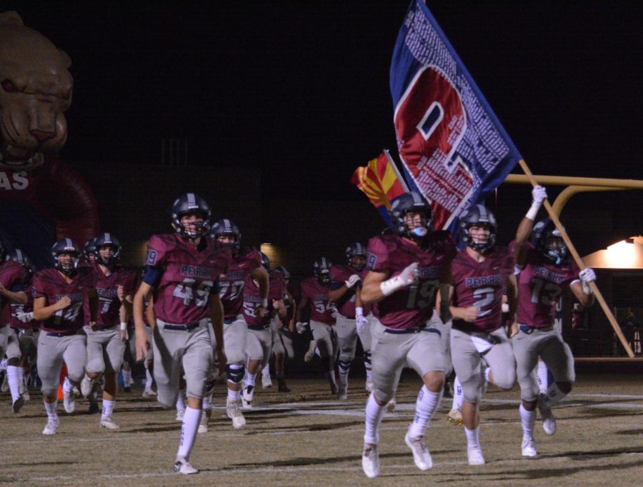 Sophomore Kolton Coleman carries the flag onto the field with Seniors AJ Baldwin, Dane Kohl, and Gavin Reetz by his side.