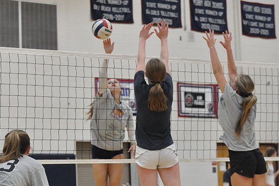 Volleyball players practicing their true and accurate form. Badminton players take up the big gym on Mondays restricting volleyball players to do full extensions in their drills.