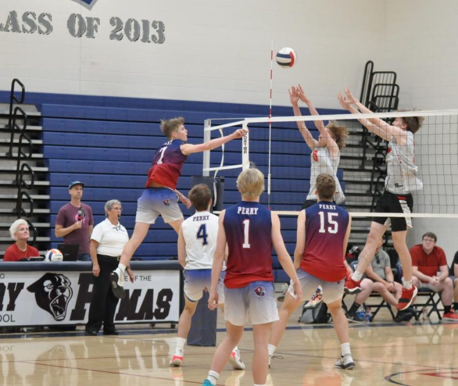 Junior Jake Anderson attempts to spike the volleyball over the net. The varsity boys volleyball team later won the match against Liberty, but lost to Highland on May 10. 