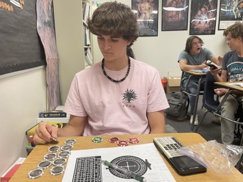 Senior Lukas Aldrich sorts his chips in preparation for a game of roulette in his AP Statistics class taught by Thomas Rothery. 
