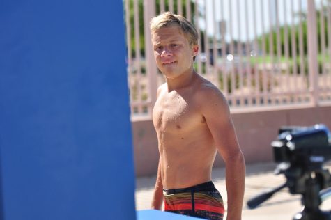 Junior diver Nathan Anderson watching back film at dive tryouts on Aug. 8th. Anderson watches the film to see what he needs to fix in his dive to improve it on the next try. 