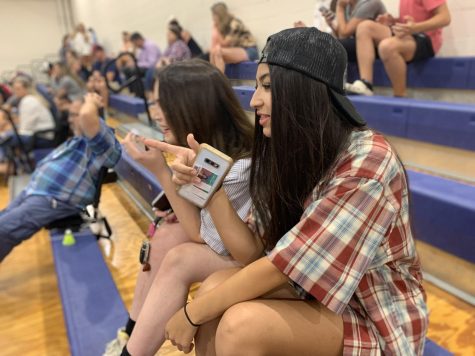 Junior Aleera Urrutia watching the girl volleyball team play on Aug. 25. Volleyball players decided on the theme (frat) and recruited people to come to their game to help with the energy in the gym.