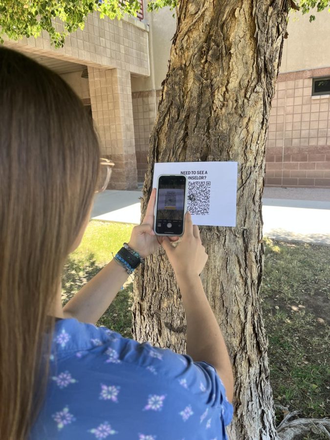 Sophomore Cayden Heddleston scans the QR code that allows her to schedule an appointment for her counselor. Students can scan their QR codes around campus to meet with their counselor. 