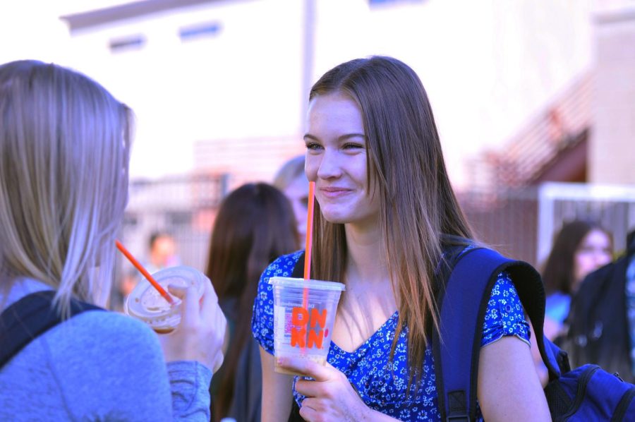 Sophomore McKayley Herr enjoys a Dunkin Donuts coffee on a September morning before classes. Herr and her friends stopped for a morning treat before a long day of school work.