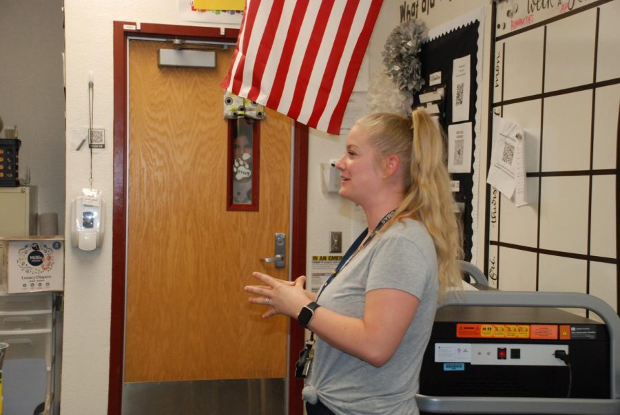 AP Literature teacher, Kimberly Rygiel conducts class, while  senior Maddie Woods tries to re-enter the locked classroom. Every door on campus must be locked, and students have mixed opinions. 