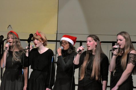 (From left to right) Natalie Park, Julia Pitman, Adithi Nythruva, Aerin Mason, and Sarah Bishop sing the song “Have yourself a merry little Christmas.” They represent holiday cheer with their festive headwear. 
