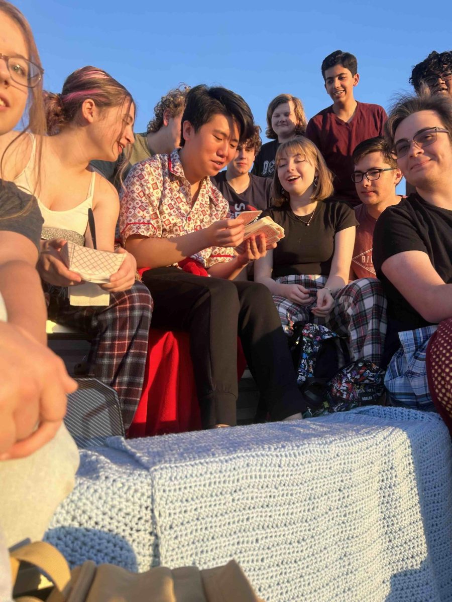 Senior Peter Mai leads a Tarot Card reading to other students during Senior Sunrise.
